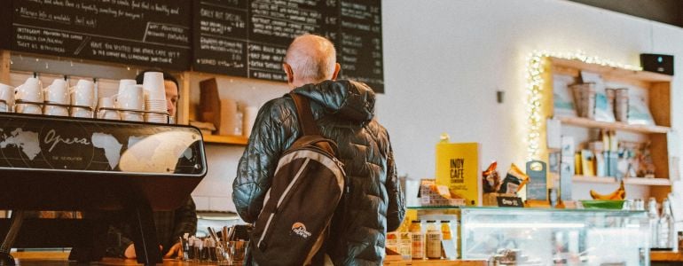 Persona disfrazada de mystery shopper en una cafetería para analizar a tu competencia